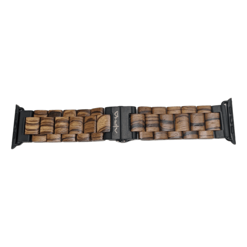 The Alpha Maui Band - Zebrawood 42mm (42-49mm) features a blend of dark and light wooden links, interwoven with each other. The clasp is black and engraved with the brand name "Arka." This band boasts a natural, rustic look that pairs perfectly with beach apparel, bringing a touch of Hawaii's Aloha spirit to your wrist.
