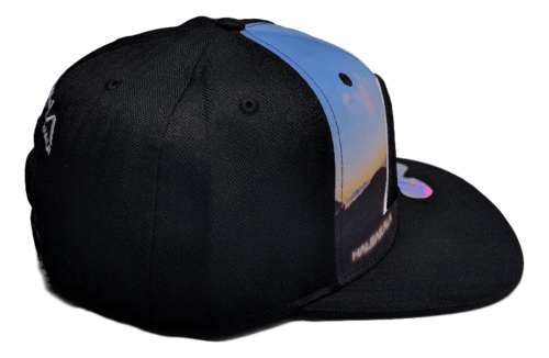 The Haleakala - Keiki Cap (Kid cap) from Alpha Maui is a black baseball cap featuring an image of a Hawaii sunset on the front panel. The brim is flat with a small sticker on it. The side panels are solid black, creating a striking contrast with the vivid beach scene, making it perfect beach apparel for any sunny day.