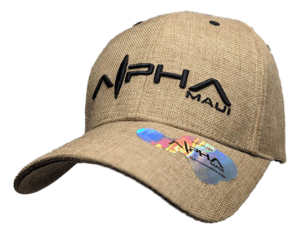 A tan baseball cap, named the Alpha Maui Regulator, features the word "Alpha" in stylized black letters and "Maui" in smaller black letters on the front. The cap includes a shiny holographic sticker near the brim, perfectly capturing that Alpha Maui vibe for anyone dreaming of Hawaii.