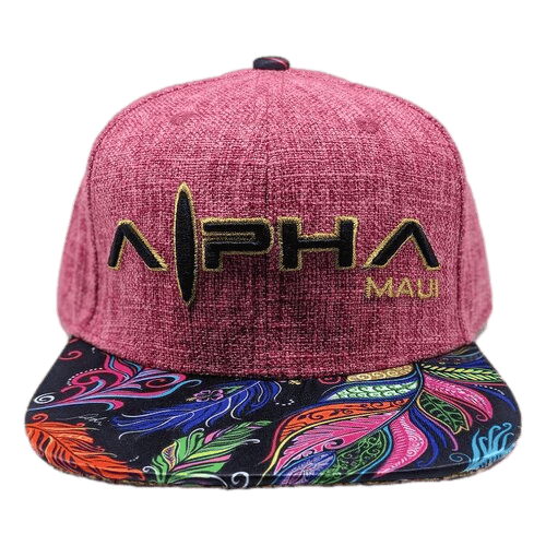 A red textured snapback hat named "Feathers" with the text "Alpha Maui" embroidered in yellow thread on the front panel. The brim features a vibrant feather pattern in shades of purple, orange, blue, and green, embodying the colorful spirit of Hawaii's Ohana.