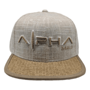A light brown baseball cap named "Wailea Grand," with "Alpha Maui" embroidered on the front in bold letters. The hat features a textured fabric design inspired by Hawaii's rich culture, paired with a contrasting bill in a woven pattern. Perfect for your next Ohana outing!