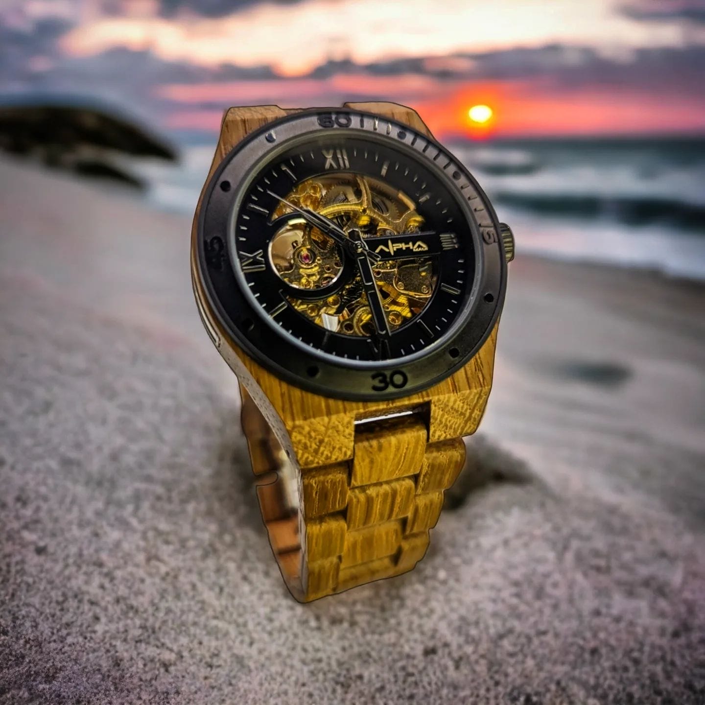 A luxury wristwatch with a wooden band and intricate skeleton dial rests on the sandy beach. The background, reminiscent of an Ohana-filled evening in Hawaii, features a serene sunset over the ocean, creating a vibrant mix of pink, orange, and purple hues in the sky.