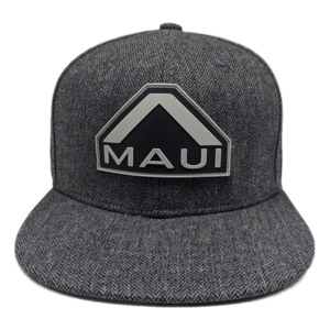 The Specialist" gray, flat-brimmed cap with a Herringbone pattern features a prominent black and white geometric logo on the front. The logo, shaped like an arrow or peak, has the word "Maui" written in uppercase letters beneath it, making it perfect beach apparel for showcasing your Hawaiian Ohana spirit.