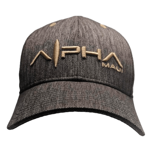 Introducing the Alpha Maui CocoNuts II, a dark gray baseball cap with a stylish herringbone pattern. The front of the cap is embroidered in beige thread, showcasing "Alpha" in larger letters and "Maui" in smaller ones to the right. This beach apparel piece embodies the spirit of Aloha with its sleek design and island-inspired vibe.
