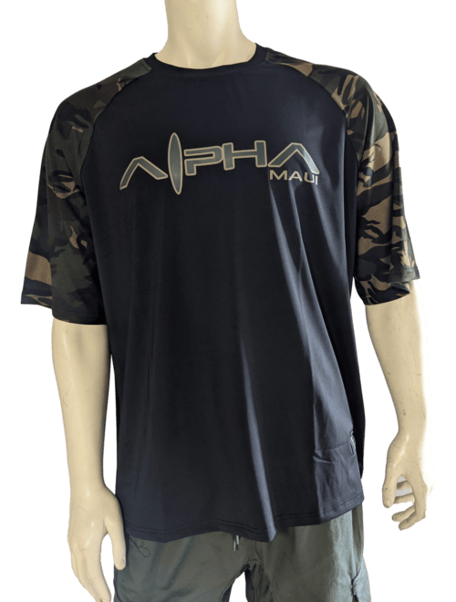 A mannequin is wearing a black Alpha Fit t-shirt with the words "Alpha Maui" printed on the front. The t-shirt features short sleeves with a camouflage pattern, evoking an Aloha spirit. The mannequin's visible lower half is dressed in green pants.