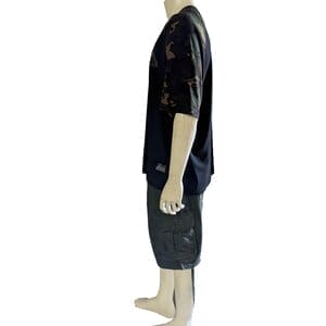 Side view of a mannequin dressed in the Armor-1 style, featuring a black shirt with dark camouflage sleeves and dark cargo shorts. The mannequin is facing to the right and has no shoes or other accessories.