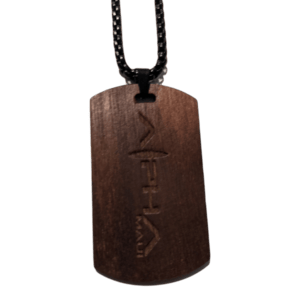 Introducing the Alpha Tag: a wooden dog tag pendant with an engraved text, hanging from a black chain. Featuring a smooth, polished finish, this rectangular pendant with rounded edges is perfect for complementing your beach apparel. This accessory embodies the spirit of Alpha Maui and the essence of Ohana.