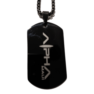 The Alpha Tag is a black dog tag pendant with a silver chain, featuring the word "Alpha" in a stylized font and the word "Maui" written vertically beneath it. This sleek, glossy piece of Alpha Maui beach apparel adds a touch of island spirit to your look.