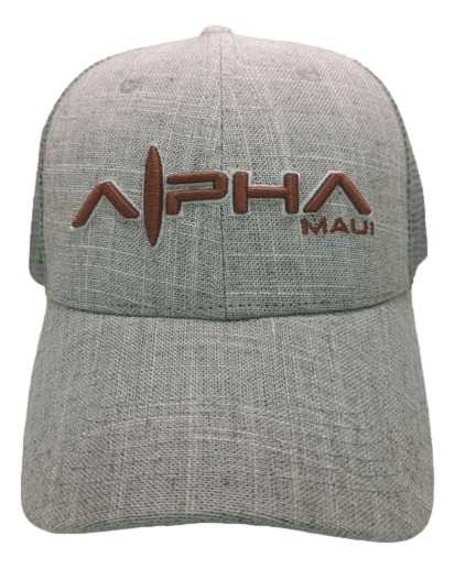 The Alpha Maui Sandy is a textured gray baseball cap with a curved brim, featuring the text "Alpha Maui" in raised, brown embroidery on the front. The letter "L" in "Alpha" is creatively designed to resemble a surfboard, capturing the essence of Hawaii and an Aloha spirit.