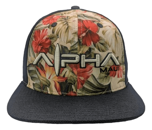 The Night Garden baseball cap features a black brim and a vibrant tropical floral pattern on the front panel. "Alpha Maui" is prominently embroidered in large letters, with "Ohana" in smaller letters below. The stylized letter "A" in "Alpha," designed to resemble a surfboard, captures the essence of Hawaii's spirit.