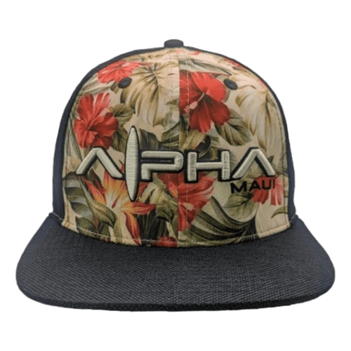 The Night Garden snapback hat boasts a vibrant tropical pattern adorned with red and yellow hibiscus flowers and lush green leaves. The front proudly features "Alpha Maui" embroidered in bold white and black letters. Perfect for complementing your beach attire, the hat's bill is solid black.