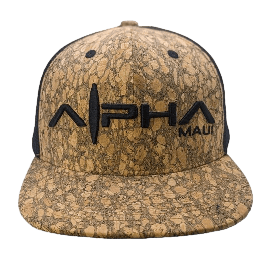 The Truckstah II cap features a unique cork-like texture with the word "Alpha" prominently displayed in bold black letters and the word "Maui" in smaller black letters to the side. This close-fit cap with a straight brim is ideal for your beach apparel, adding a touch of Aloha spirit to your outfit.