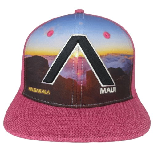 The Haleakala Pink cap for adults showcases a scenic sunset or sunrise over mountains and clouds. It features a large black letter "A" in the center, with "HALEAKALA" written in yellow and "Maui" in white text beneath it. This cap is perfect beachwear that captures the essence of Aloha.