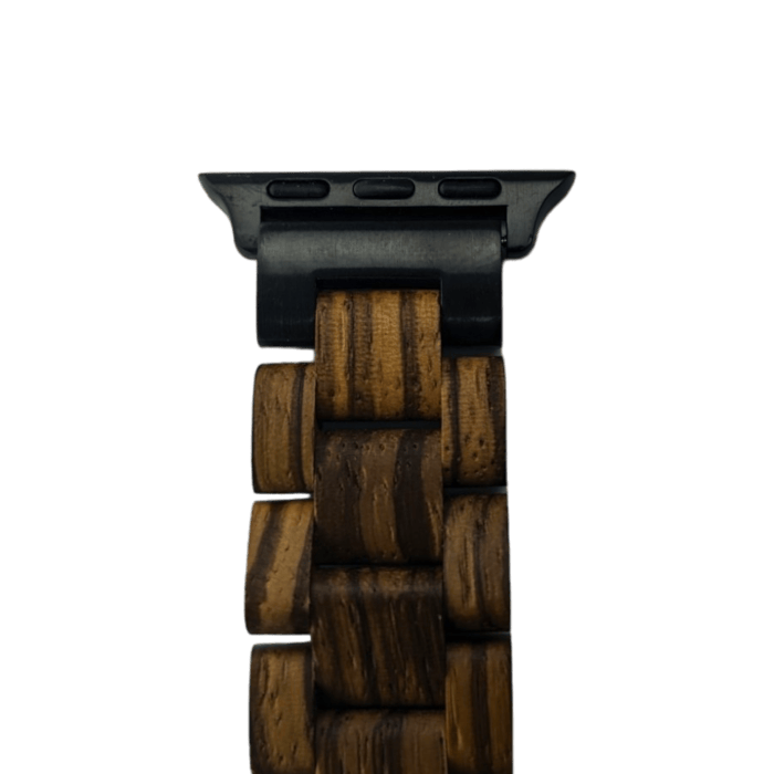 A close-up of the Alpha Maui Band - Slim (38-41mm) shows a wooden watch strap with rectangular links, attached to a black metal connector. The strap features alternating light and dark wood grains, highlighting its intricate craftsmanship. Inspired by the spirit of Ohana, this design celebrates Hawaii's natural beauty. The black connector piece has three visible screw holes.