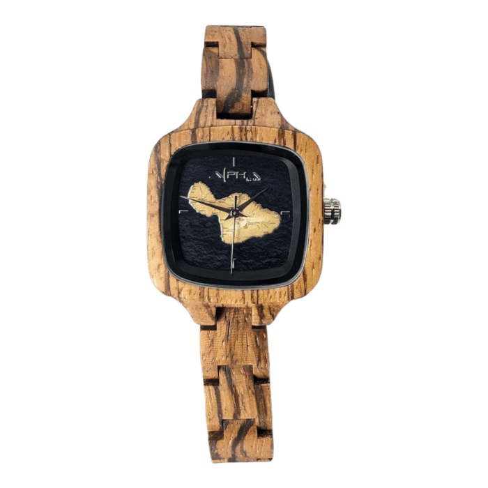 The Wahine is a wooden wristwatch with a square face, featuring a black dial adorned with a gold map design. It has a wooden link strap and a silver crown on the right side for time adjustments. Perfect for beach apparel, the brand name "Vtila" is displayed on the dial above the map, evoking an Ohana spirit reminiscent of Hawaii.