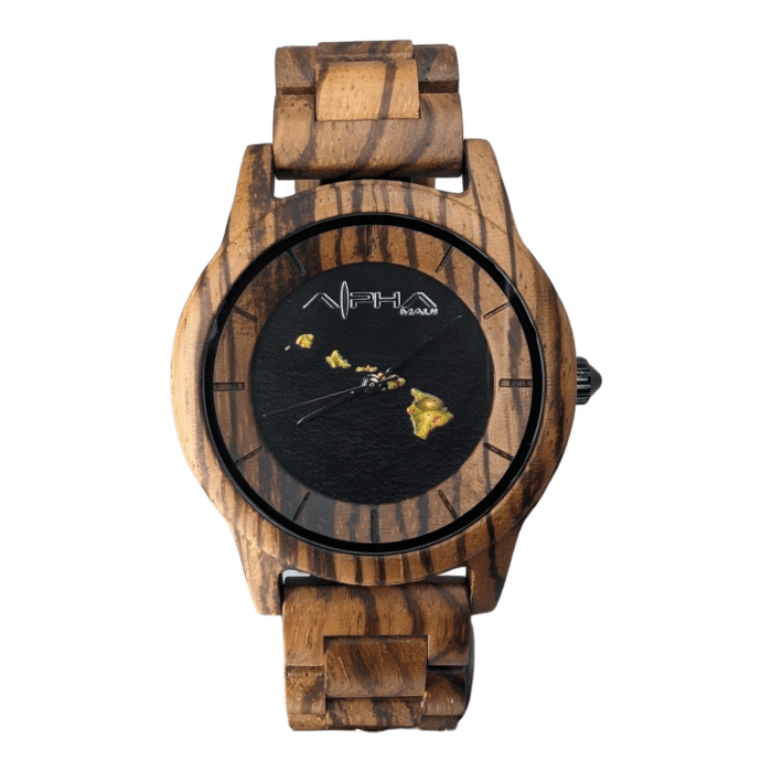 The "Island Time" wristwatch features a wooden band and casing, making it an ideal accessory for beach enthusiasts. Its black watch face is adorned with gold hour markers and a small gold map of the Hawaiian Islands. The brand name "Alpha Maui" is elegantly printed near the top, with a small gold marker designating the 12 o'clock position.