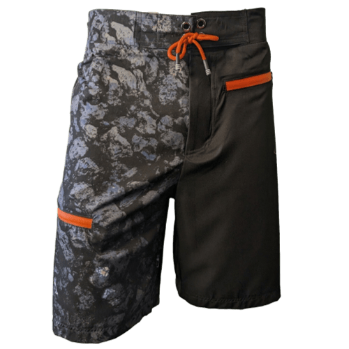 Introducing the Lava Flow men's board shorts: a unique mixed design with black fabric on the right side and a dark grey camo pattern in varying shades of grey and black on the left. Perfect for Aloha beach outings, these shorts feature two orange zipper pockets and an orange drawstring at the waist.