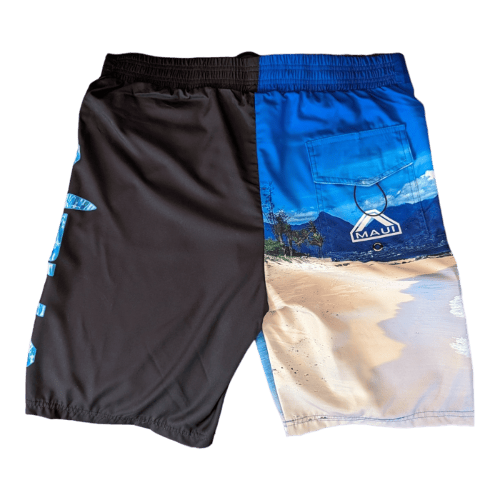 The Lava Flow two-tone beach apparel shorts feature a solid black left side adorned with blue Hawaiian-themed text, while the blue right side showcases a vibrant beach scene with palm trees and an "Alpha Maui" label on the rear pocket. These stylish shorts also come with a comfortable elastic waistband.