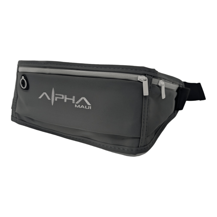 A gray Alpha Waist Pack, featuring a front zipper pocket and a headphone jack slot on the top left side. The bag, epitomizing sleek modern design and exuding a touch of Aloha, is perfectly showcased against a plain black background.