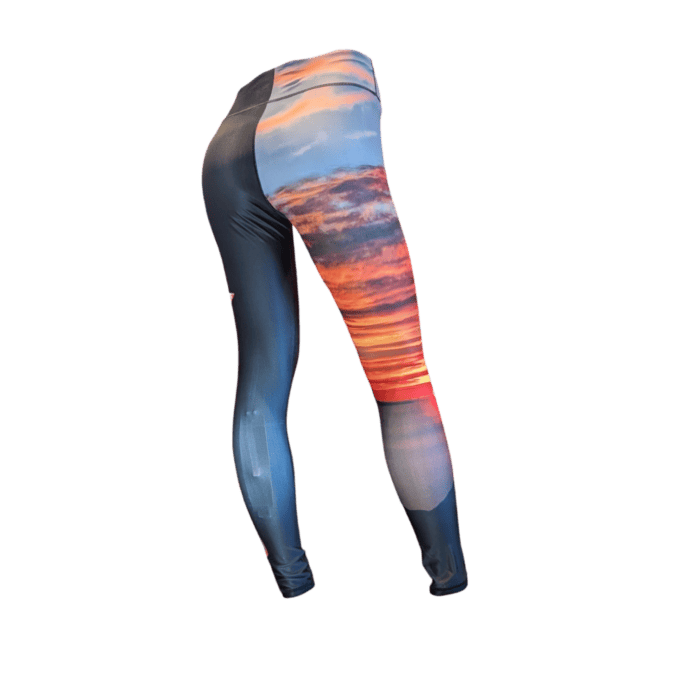 The Alpha Maui Haleakala Full Length leggings showcase a vibrant sunset print with vivid cloud patterns and rich orange and blue tones, depicted from the back view.