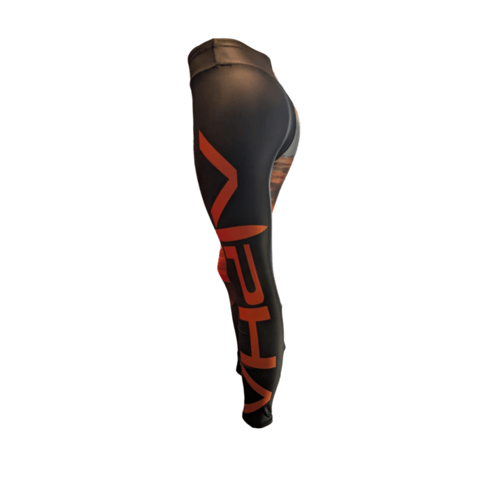 Side view of the Alpha Maui Haleakala black athletic legging featuring bold red vertical text and patterns along the outer leg, appearing stretchy and form-fitting. The image is isolated on a plain background.