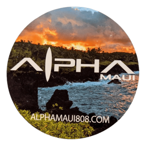 A round logo with "Let The Universe...Do It's Thing" in bold, stylized font against a dramatic sunset over a lush, green landscape and ocean waves. The text "alphamaui.com" is at the bottom, embodying the spirit of Aloha and the essence of Ohana in Hawaii.