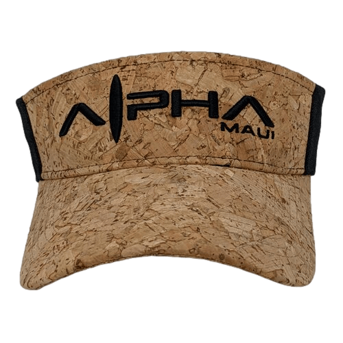 The Alpha Maui "The Cork Drop" visor boasts a cork-textured design with black trim, featuring "Alpha Maui" in bold black letters on the front. Its natural, earthy appearance makes it the perfect accessory for beach apparel enthusiasts who embrace the spirit of Aloha.