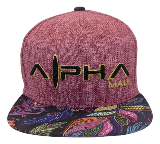 A maroon snapback cap named "Feathers" with the text "Alpha Maui" embroidered in black and yellow. The flat brim showcases a vibrant, colorful paisley pattern featuring a variety of swirling shapes and colors, capturing the spirit of Hawaii and Ohana.