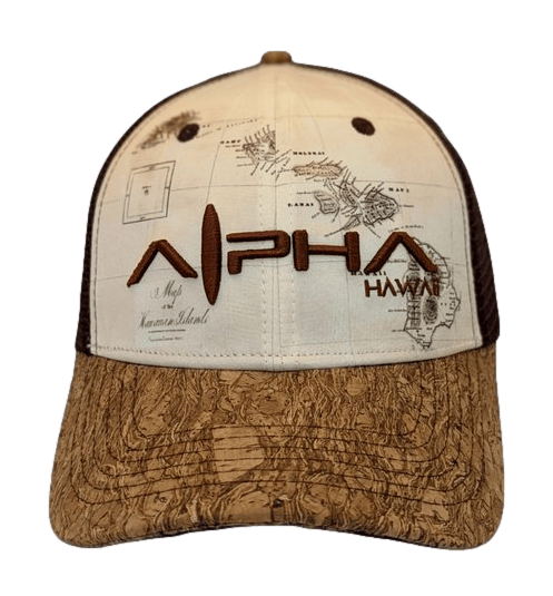 The Alpha Maui Wailea Islander is a beige and brown hat with intricate embroidered details. The front prominently features "Alpha Hawaii" in brown stitching. The light brown fabric on the front showcases a map-like design, while the brim is adorned with a textured, wood-like pattern. This hat, ideal for beachwear, also includes a mesh back for added comfort and style.