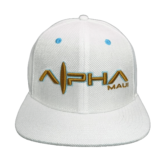 A Ghost Cream baseball cap with the words "Alpha Maui" embroidered on the front in gold and blue letters. The cap features a textured fabric, a flat brim, and radiates the spirit of Aloha.