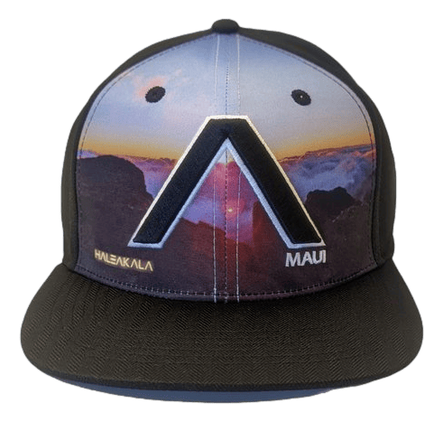 The Haleakala - Keiki Cap (Kid cap) is a black baseball cap showcasing a vibrant sunset scene with clouds and mountains on the front panel. The words "Haleakalā" and "Maui" are elegantly displayed in gold lettering on either side, with a large, stylized "A" prominently featured in the center of the design, making it a perfect addition to your beach apparel collection.