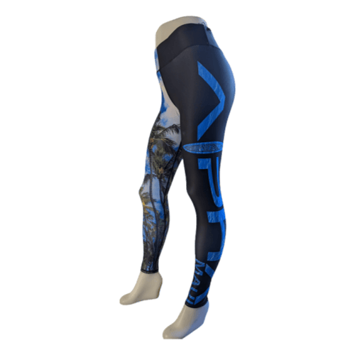 A pair of Alpha Maui Hawaii (Full Length) leggings displayed on a mannequin showcase a tropical design with palm trees adorning one leg and large, stylized blue text "Ohana" on the other. Perfect for adding a touch of Hawaii to your beach apparel collection, the background color is primarily dark.