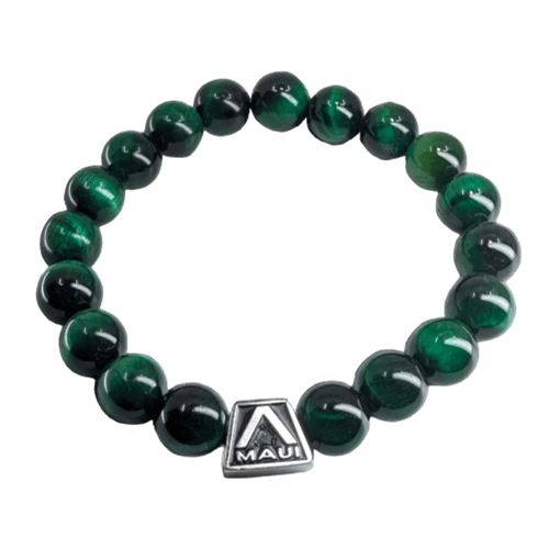 The Green Tigerlet bracelet showcases polished dark green round beads, featuring a small, square, silver-colored charm inscribed with the word "Maui" and an "A" logo above it as its centerpiece. It's perfect for complementing your beach attire and radiating the spirit of Aloha.