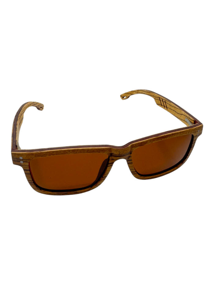 The Cruisers 2.0 wooden sunglasses feature orange-tinted lenses, a rectangular frame, and silver rivets on the front corners.