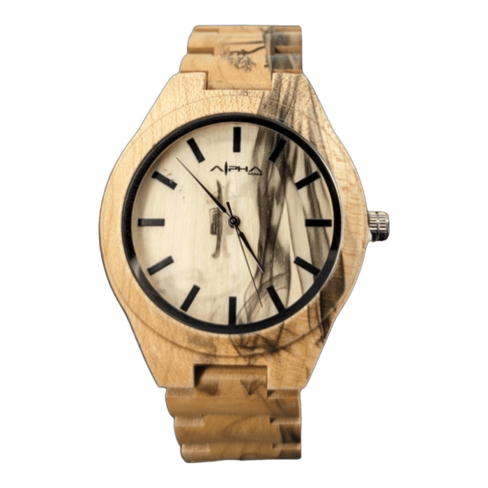 The Shield wristwatch is showcased against a black background, featuring a wooden frame and band. The light-colored watch face displays a wood grain pattern, complemented by black hour markers and hands. Below the 12 o'clock position, the brand name 'Alpha Maui' is printed in black, exuding an island-inspired elegance.