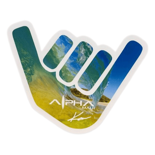 A shaka hand gesture with an image of a wave crashing onto a beach inside it. The thumb and pinky are extended while the other fingers are folded down. The design, perfect for beach apparel, features the text "Alpha Maui" along with a signature near the bottom of the hand and is titled "Let The Universe...Do It's Thing.