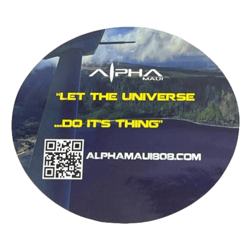 A circular sticker titled "Let The Universe...Do It's Thing" showcases the Alpha Maui logo against a picturesque backdrop of Hawaii's mountains and sky, accompanied by the inspiring text "LET THE UNIVERSE ...DO ITS THING." Beneath this message, you'll find a QR code and the website address alphamaui.com. Embrace the Aloha spirit with every glance!