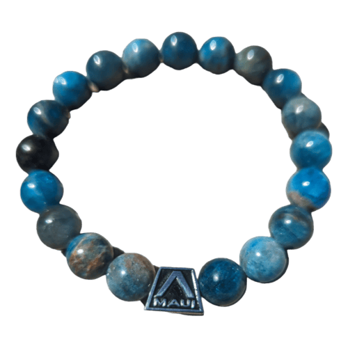 Introducing the Alpha Maui LangLinglet: a circular bracelet adorned with spherical blue stones in varying shades. Among the stones, a small metal square charm featuring the word "Maui" and an Alpha "A" logo is attached, perfectly capturing that laid-back Aloha spirit. Presented against a white background, this bracelet epitomizes beach apparel elegance.