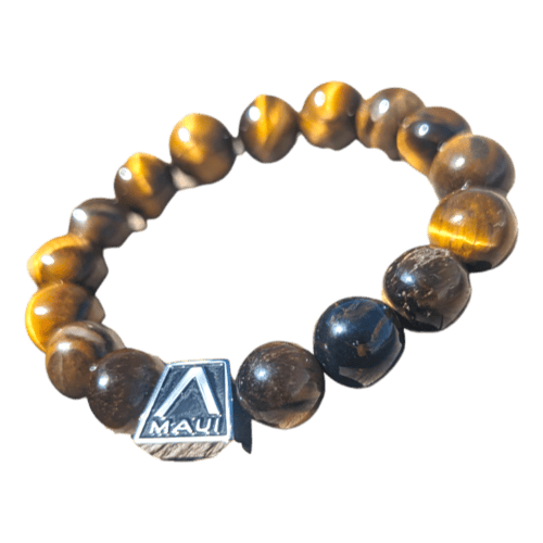 The Alpha Maui LangLinglet is a beaded bracelet crafted from polished brown and golden tiger's eye stones, with round beads strung together on an elastic band. It features a small silver charm engraved with the insignia "Alpha Maui.