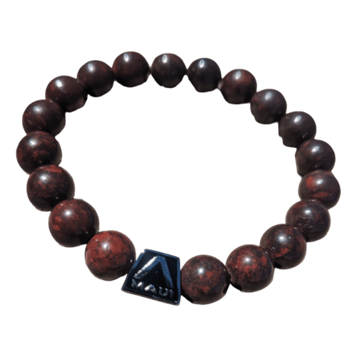 The Alpha Maui LangLinglet is a beaded bracelet featuring dark brown, round beads strung together on an elastic band. One of the beads is a distinctive black square with an "A" logo and the text "HAKU," positioned towards the bottom of the bracelet. This piece from Alpha Maui perfectly complements any beach apparel, embodying that Ohana vibe.