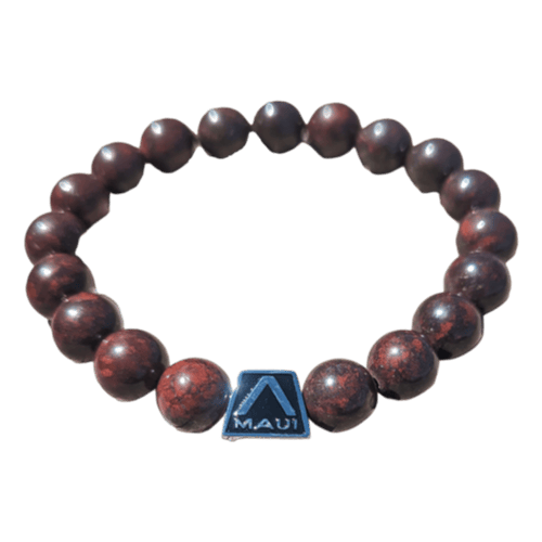 Introducing the Alpha Maui LangLinglet: a beaded bracelet featuring round, dark brown stones and a striking black rectangular bead inscribed with "Maui" and adorned with a small white triangular logo. This bracelet, arranged in a stylish circular shape, is the perfect addition to your beach apparel collection.