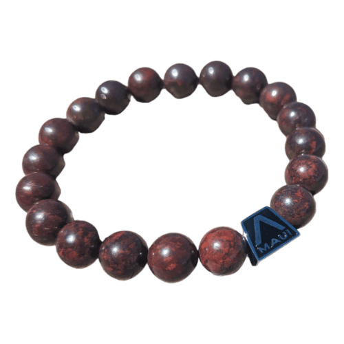 The Alpha Maui LangLinglet is a beaded wrist bracelet composed of round, dark red stone beads, strung together with a clear elastic thread. It features a small dark blue rectangular tag on one bead, showcasing the word "Alpha Maui" alongside a geometric logo. The bracelet is presented against a white background.