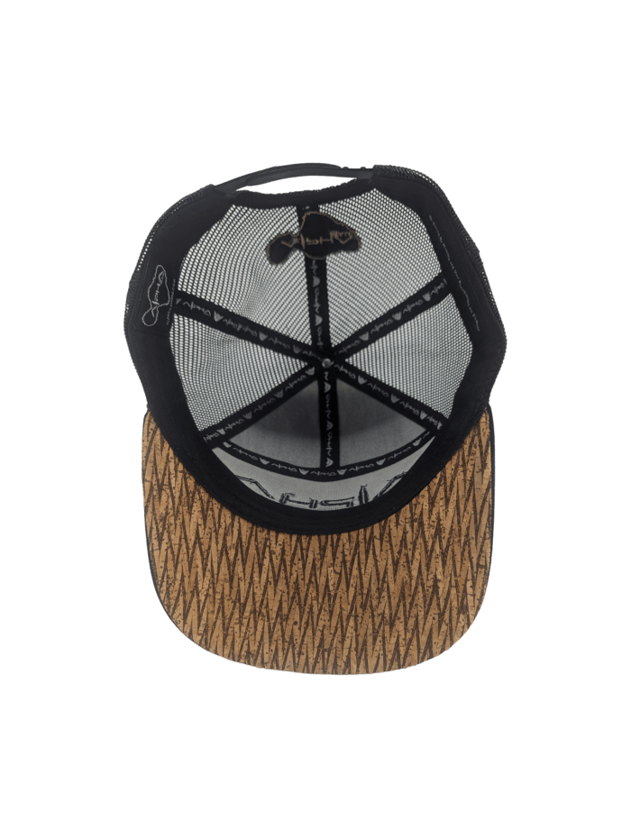 The Alpha Maui Mauka is a black baseball cap featuring a brown patterned bill and a mesh back, making it an ideal addition to your beach apparel. Pictured from the inside view, the cap showcases its curved brim and the visible stitching on the inner side that highlights its construction. The mesh panels are connected by fabric strips for added durability.