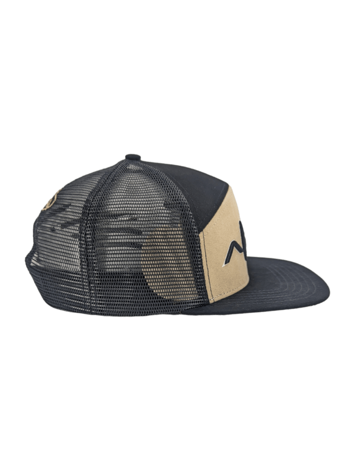 The Alpha Maui Kahmani is a black and beige trucker cap featuring a mesh back and flat brim, prominently displaying the Alpha Maui logo. The front panel is beige with a portion of the black logo visible, while the side and back panels are crafted from black mesh for optimal ventilation. The cap is depicted in a sideways position.