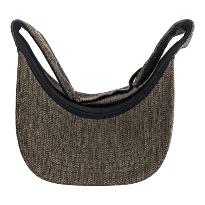 A flat cap, the Alpha Maui Mauka, is crafted from brown tweed fabric and displayed against a black background. The visible brim at the bottom and dark interior lining highlight its design. The cap is folded at the back, showcasing its patterned texture and sturdy brim—a subtle nod to Alpha Maui's timeless style.