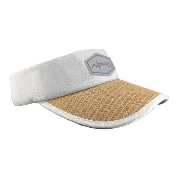 The Alpha Maui Mauka is a white visor hat with a beige woven brim. On the front, it features a small hexagonal patch with a logo and the text "Aloha." The visor has a slightly curved shape and textured appearance on the brim, contrasted against a smooth fabric band. The background is plain black.