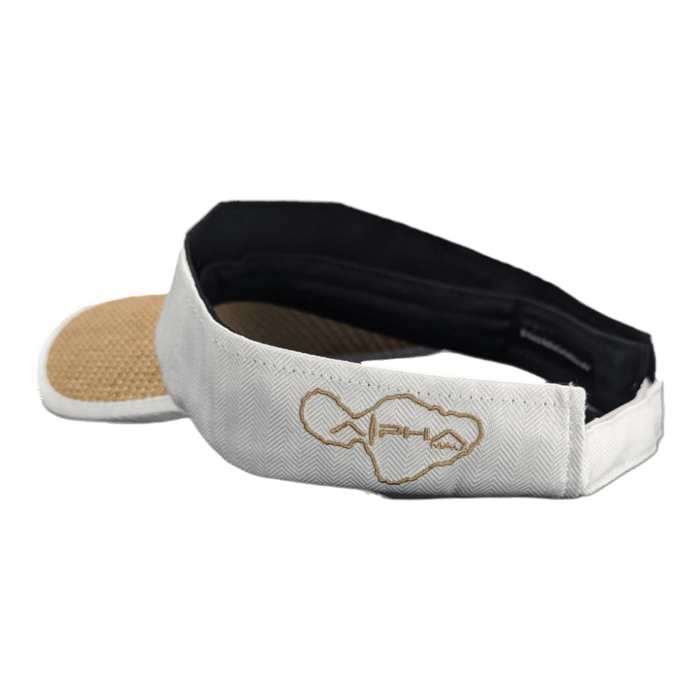 The Alpha Maui Mauka is a white visor with a black inner lining and a brown underbill. The front features an embroidered outline of the Hawaiian Islands with a heartbeat symbol, radiating Aloha. The back is open and has an adjustable strap.