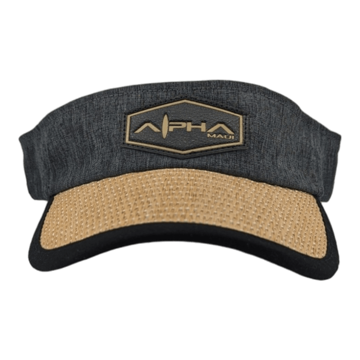 The Alpha Maui Mauka visor hat boasts a dark gray design with a woven beige brim and a black underside. Ideal for beach wear, it features a hexagonal patch on the front with "APHA" and "Maui" inscribed, adding a dash of Aloha spirit.