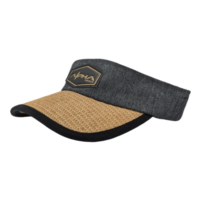 The Alpha Maui Mauka visor hat features a light brown, woven straw brim and a dark gray band adorned with a black and gold embroidered logo patch on the front. This stylish accessory from Alpha Maui is designed for sun protection and fashion, making it the perfect addition to your beach apparel for your Hawaii getaway.