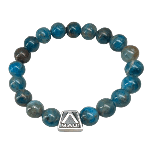 The Alpha Maui LangLinglet is a circular beaded bracelet made of round, blue gemstone beads. A silver square-shaped charm with the word "Maui" and a sailboat logo is attached among the beads, encapsulating the spirit of Aloha.